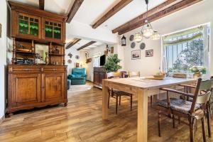 a dining room with a wooden table and chairs at Landsitz Blankensee in Blankensee