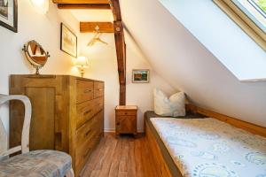 a attic bedroom with a bed and a dresser at Landsitz Blankensee in Blankensee