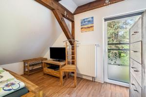 a bedroom with a bed and a desk with a television at Landsitz Blankensee in Blankensee