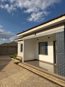 a rendering of a house with a driveway at MAI instahomes in Lilongwe