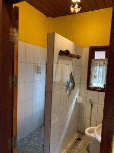 a bathroom with a shower with a toilet and a window at Huan Aumpron Resort in Ban Kha Ngam