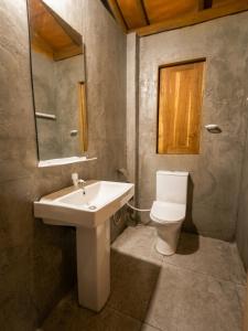 a bathroom with a sink and a toilet at Tree House Cabana Sigiriya in Sigiriya