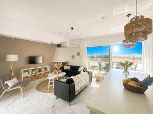 a living room with a couch and a table at Lilu Villa 2 with Private Pool and Seaview in Tigaki