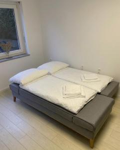 a bed in a room with two pillows on it at Apartment mit Terrasse - Nähe CHIO Aachen in Herzogenrath