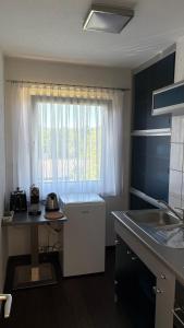 a small kitchen with a sink and a window at Haus am Waldrand in Göttschach