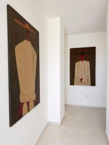a room with two pieces of art on a wall at Villa Azur in Draç
