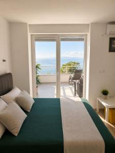 a bedroom with a large bed with a view of the ocean at Apartments Marko in Ohrid