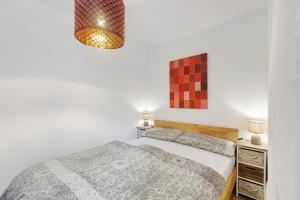 a bedroom with a bed and a lamp at Premium Ferienwohnung Dörr in Singen
