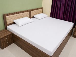 two beds in a room with a large mattress at Bindwasini Hotel And Party Palace in Bīrganj