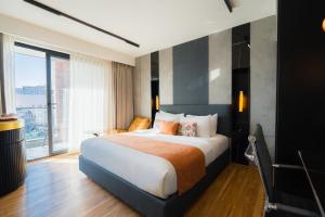 a hotel room with a bed and a large window at Hotel Limon Sector 45 Gurgaon in Gurgaon +75 photos