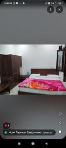 a bedroom with a bed with a red blanket at Tapovan ganga view in Uttarkāshi