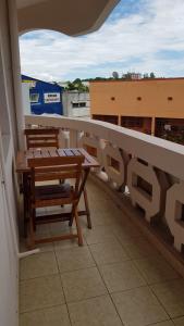 a balcony with tables and chairs on a building at Appart'hotel Les Capucins in Mahajanga