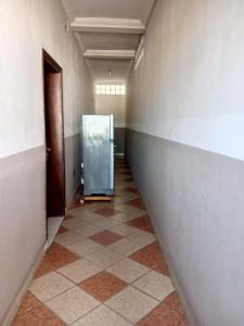 a hallway with a glass door in a room at Appart'hotel Les Capucins in Mahajanga