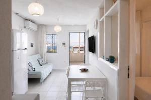 a white living room with a couch and a table at Seaview Apart Bodrum in Bodrum City