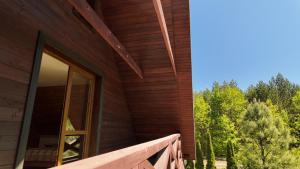 a wooden house with a large window on the side of it at Jakubowo in Długi Bród