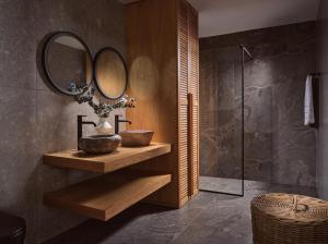 a bathroom with a sink and a mirror at Theros Luxury Suites in Agios Nikolaos +38 photos