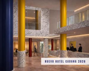 a lobby of a hotel with two people sitting at a counter at Hotel Cabana in Benidorm