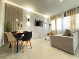 a living room with a couch and a table at DNS Elements Apartments 2 in Nea Karvali