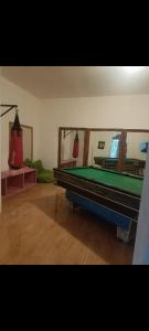 a room with a pool table and a mirror at Gandasari homestay banyuwangi in Banyuwangi