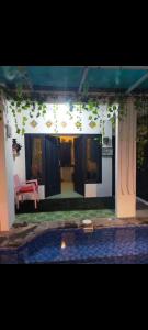 a house with a red bench in the middle of a yard at Gandasari homestay banyuwangi in Banyuwangi