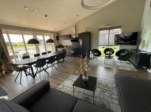 a living room with a couch and a table and chairs at Beach House 314 in Hindeloopen