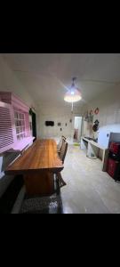 a kitchen with a large wooden table and chairs at Gandasari homestay banyuwangi in Banyuwangi
