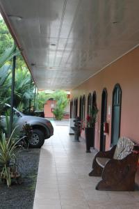 Hotel Vista al Tortuguero في Cariari: ممر فيه سيارة متوقفة في مبنى