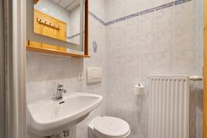 a white bathroom with a sink and a toilet at Lienelehof in Moso +37 photos