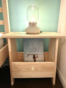 a table with a lamp and a book on it at MARSEA Resort in Zushi
