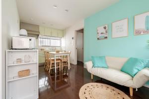 a living room and kitchen with a couch and a table at MARSEA Resort in Zushi
