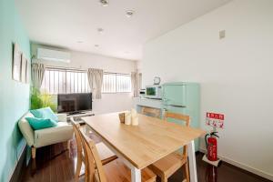 a kitchen and dining room with a wooden table and chairs at MARSEA Resort in Zushi
