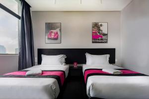 a hotel room with two beds and a pink car at Apex by Bukit Bintang Hotel in Kuala Lumpur +7 photos