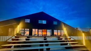 a building with stairs in front of it at night at B&B Landgoed de Bossenhoeve in Schayk