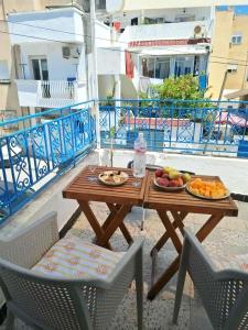 a wooden table with fruit on top of a balcony at Les Sables Bleus in Le Kram