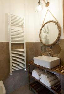 a bathroom with a sink and a mirror and towels at Vigne Del Garda in Villafranca di Verona +8 photos
