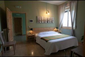 a bedroom with a large bed and a window at Vigne Del Garda in Villafranca di Verona