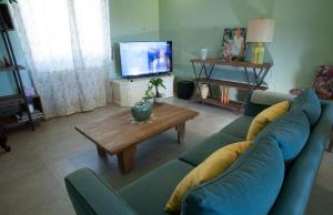 a living room with a blue couch and a coffee table at Vigne Del Garda in Villafranca di Verona