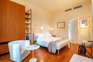 a bedroom with a bed and a chair and a table at Villa Rosmarino in Camogli +28 photos