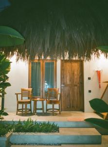 a room with two chairs and a table and someotics at Oemau Bungalow in Nembrala