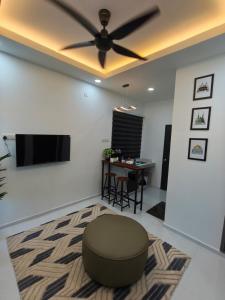 a living room with a ceiling fan and a table at The Kobe House 2 in Kuala Berang