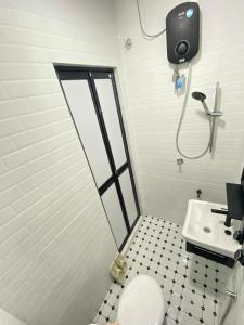 a bathroom with a toilet and a sink at The Kobe House 2 in Kuala Berang +10 photos