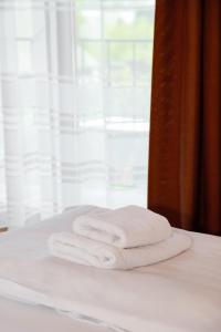 a stack of towels sitting on top of a bed at Sukhoviia in Yasinya +45 photos