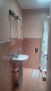 a bathroom with a sink and a shower at Punto Sur Departamentos in Tandil +42 photos