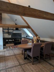 a dining room with a wooden table and chairs at BoerLangendijk in Rucphen