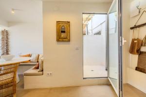 a bathroom with a glass door leading to a living room at Apartment with sea view Javea in Jávea +67 photos