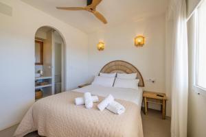 a bedroom with a large bed with towels on it at Apartment with sea view Javea in Jávea