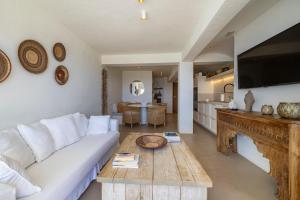a living room with a white couch and a table at Apartment with sea view Javea in Jávea