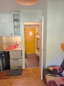 a kitchen with a sink and a yellow door at Résidences de Mélisa La Foux d'Allos in La Foux d'Allos +143 photos
