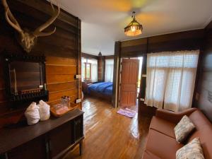 a living room with a couch and a fireplace at มาดูดอย - Madoodoi in Ban Mae Na