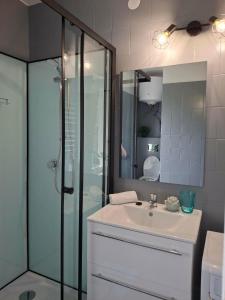 a bathroom with a sink and a shower at Bella Garden in Balatonszárszó